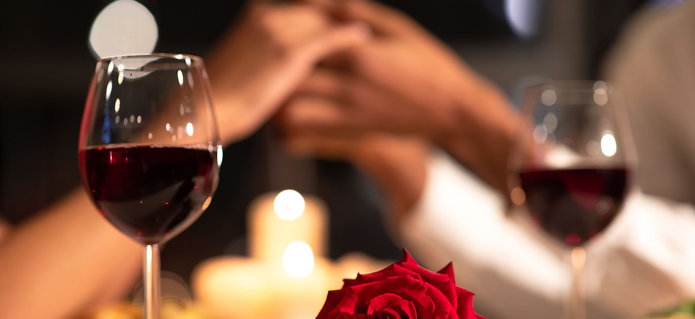 Romantic Date. Red Rose Lying On Table, Loving Afro Couple Holding Hands During Valentines Dinner In Restaurant. Selective Focus