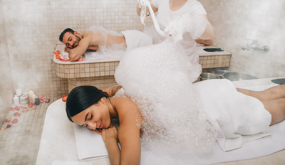 Hammam clients enjoying a foam massage in a Turkish bath. Procedures in oriental bath improves skin and stops aging process
