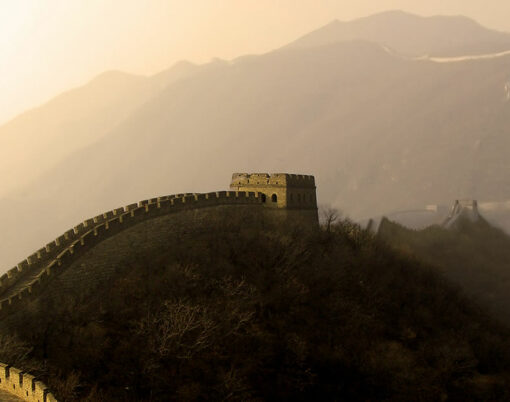 the great wall of china (mu tian yu) under a setting sun.