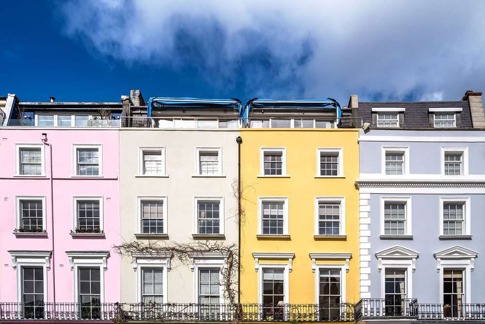 Detail of colourful terraced townhouses with summer sky background