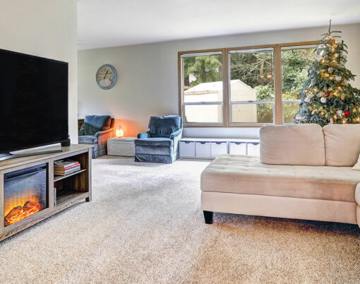Neutral toned family room boasts L shaped light linen sectional facing Electric fireplace TV stand . Northwest USA