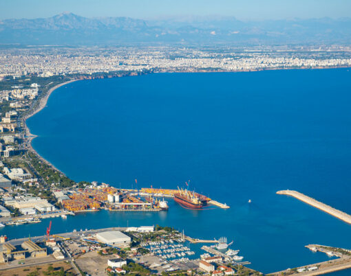Aerial view of beautiful blue gulf and Konyaalti beach in popular resort city Antalya, Turkey.