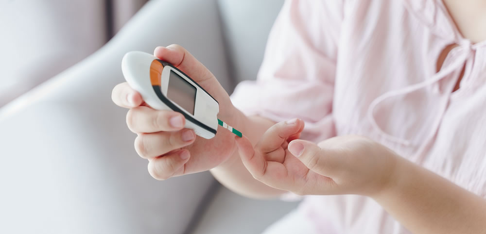 Asian woman checking blood sugar level by Digital Glucose meter, Healthcare and Medical, diabetes, glycemia concept