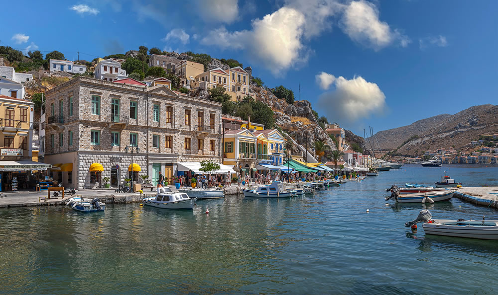 Symi harbour, with colorful neoclassical mansions covering the slopes near the main city