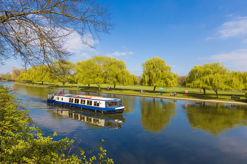 local cruise tour boat cruising along a river at Stratford upon Avon Warwickshire