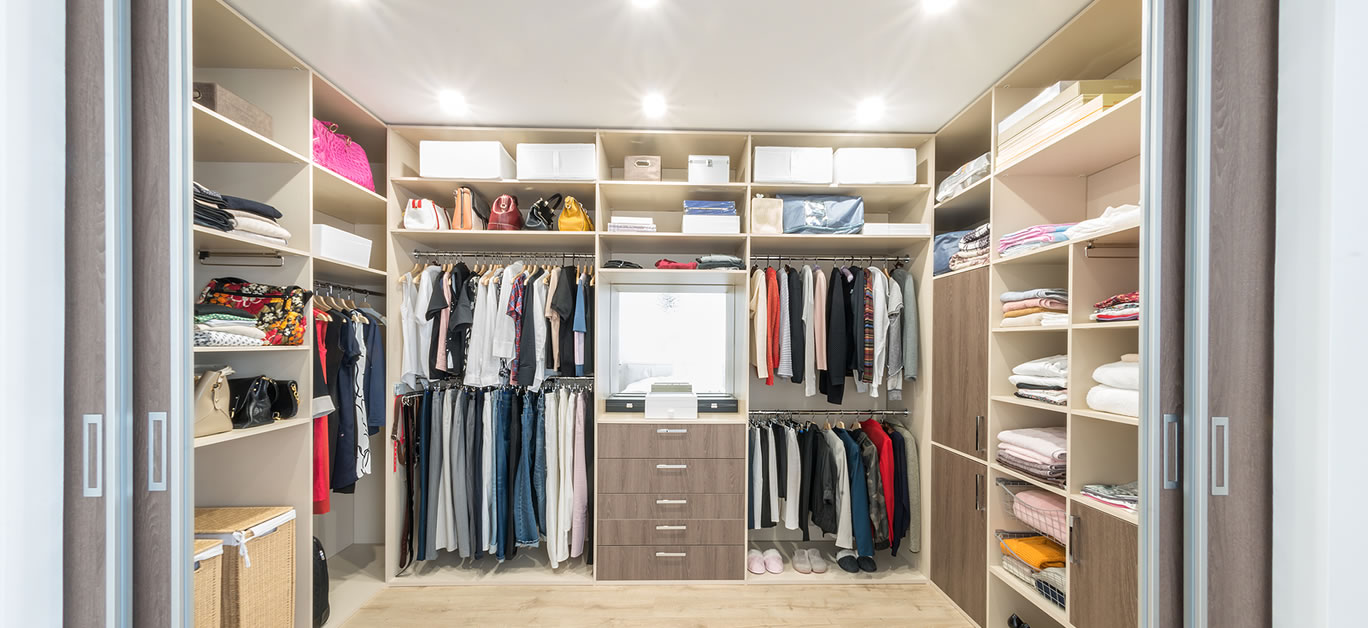 Big wardrobe with different clothes for dressing room