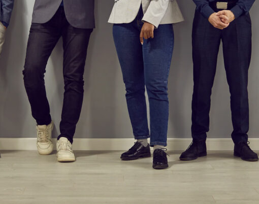 Cropped shot of legs of team of business people in smart casual clothes of standing in office