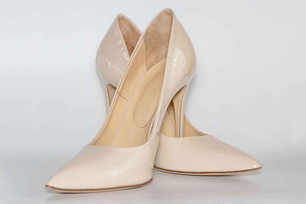 Front view of the nude colored high heeled womens shoes.