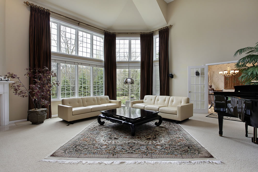 Large family room with two story windows