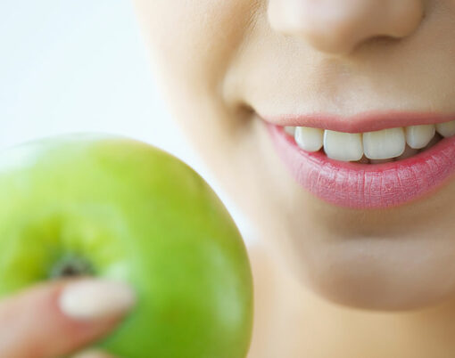 Woman Eating Apple. Beautiful Girl With White Teeth Biting Apple