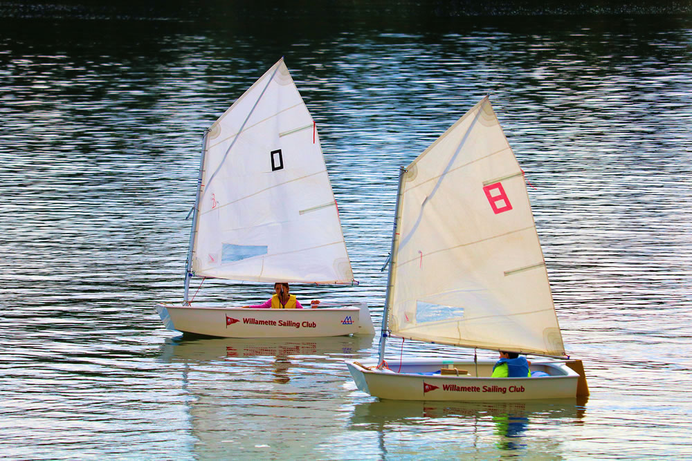 People sailing on miniature sail boats taken on the Willamette River in Portland