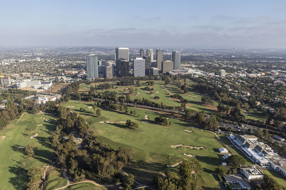 Afternoon aerial view of Century City towers and the Los Angeles Country Club Golf Course.