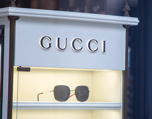 Gucci signage facade store eyeglasses entrance logo brand and text sign Italian fashion and leather goods brand