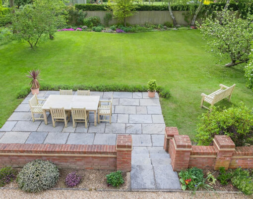 Garden patio furniture and large lawn in luxury back garden, UK