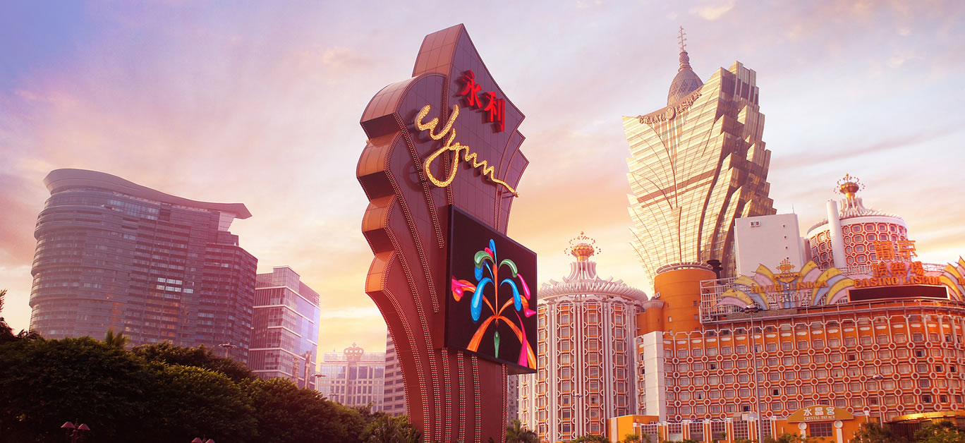 The sunset facades of Grand Lisboa Macau casino resort and Wynn luxury hotels in Macau Peninsula