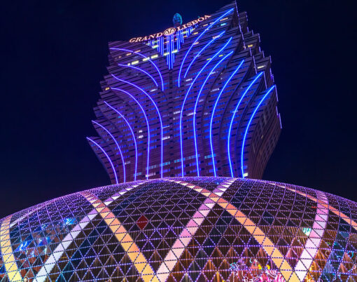 tallest tower in Macao and the big dome of Grand Lisboa Casino at night.