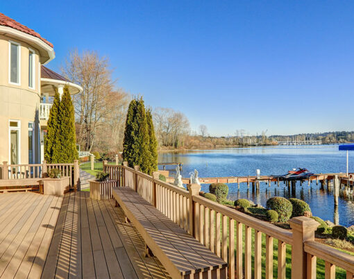 Sunny spacious walkout deck of luxurious Mediterranean style waterfront home overlooking picturesque view of Lake Washington. Northwest USA