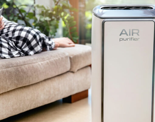 Air purifier cleans up air. Modern air purifier cleans up the air in the living room with woman lying on the couch. logo on the device was created in graphic program