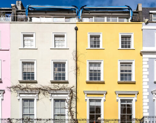 Detail of colourful terraced townhouses with summer sky background