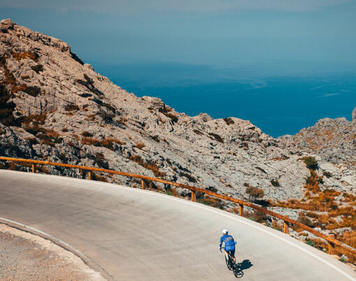 Man ride on bicycle in Famous Sa Calobra Climb in Mallorca. Original sport wallpaper