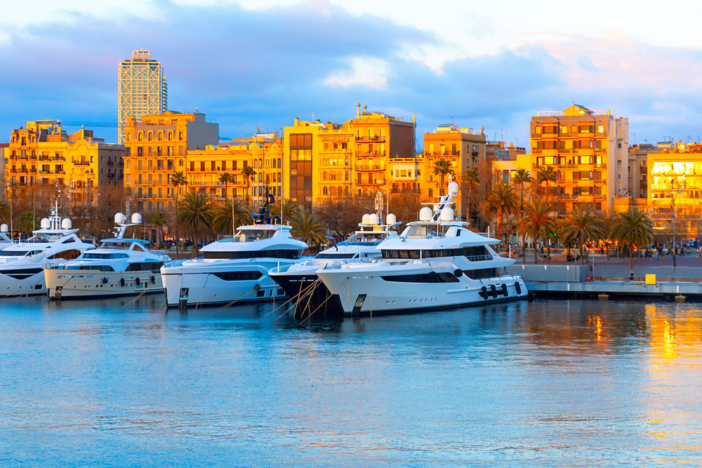Yachts in harbor of Barcelona . Moored luxury nautical vessels