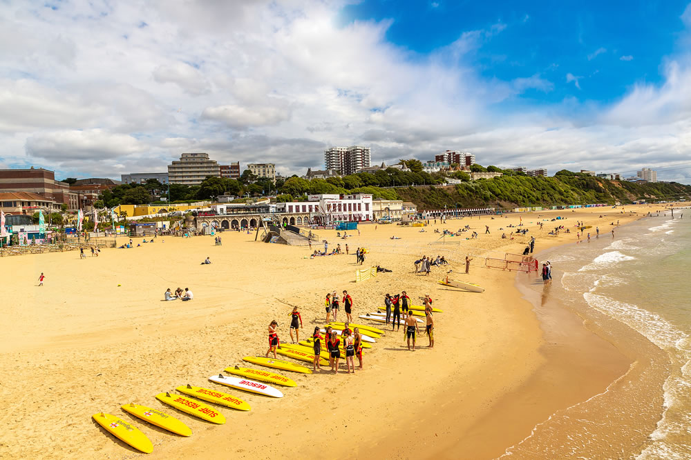 Group of Lifeguards and Rescue Boards at Bournemouth beach in a sunny summer day in Bournemouth, Dorset, UK