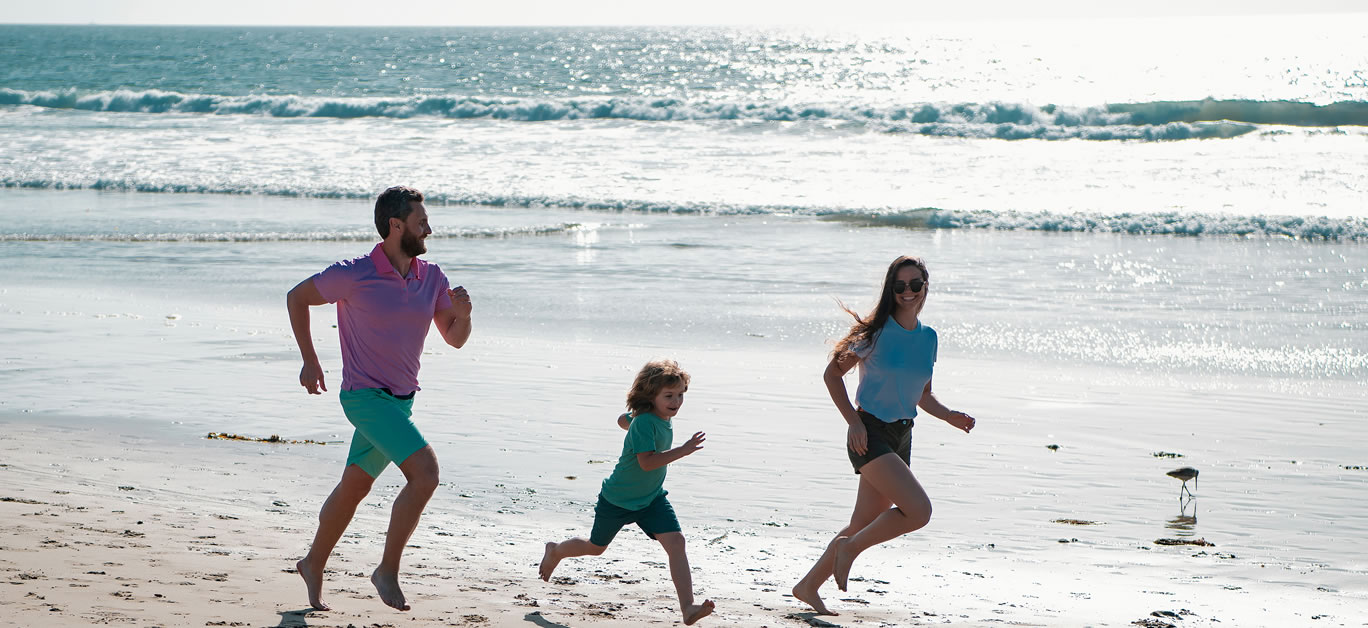 Cheerful family running on the beach
