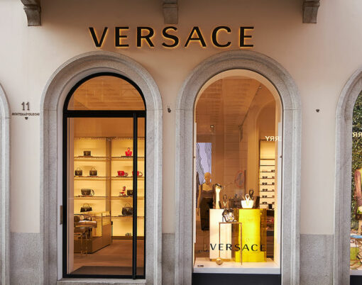 Illuminated showcase of Versace store. Front door to the store
