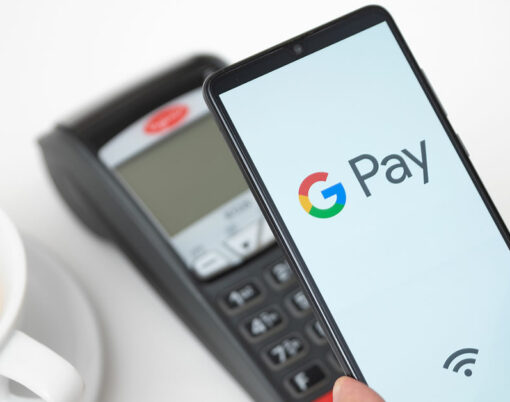 Man holding smartphone with Google Pay logo