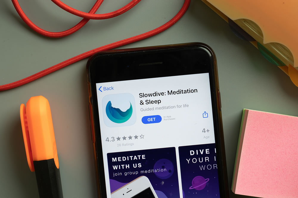 Slowdive Meditation and Sleep mobile app logo on phone screen close up, Illustrative Editorial.