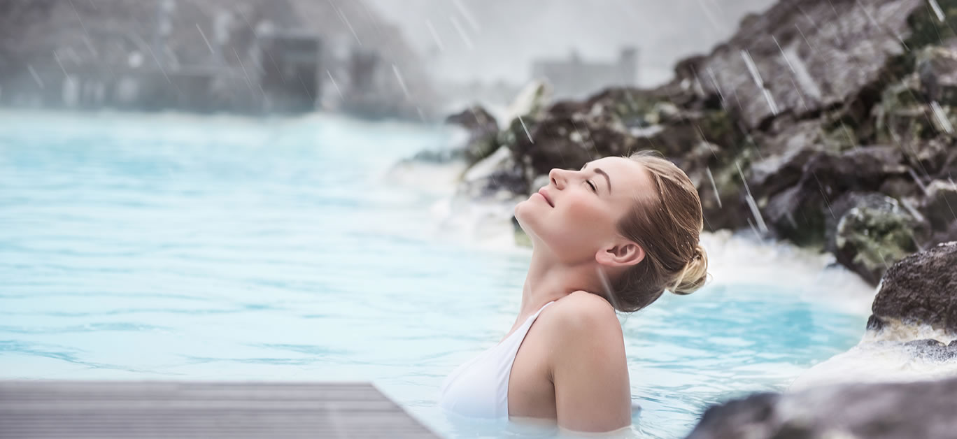 Woman enjoying natural spa, Blue Lagoon is a geothermal spa in southwestern Iceland, is located in a lava field near Grindavk on the Reykjanes Peninsula