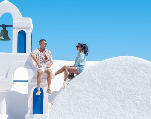 couple men and woman on vacation Santorini Greece. young couple on vacation in Greece
