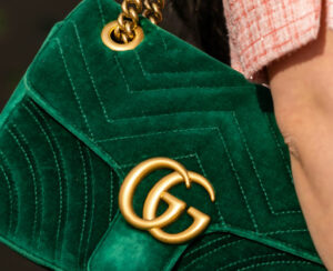 woman wearing velvet green Gucci Marmont bag, street style outfit details.