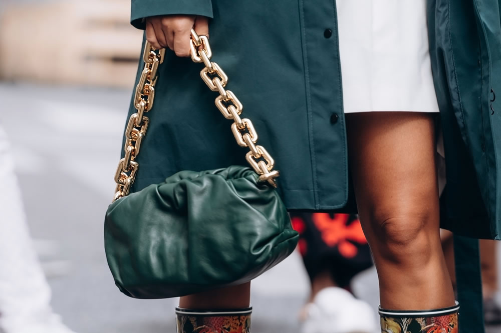woman wears handbag Bottega Veneta shoulder pouch leather shoulder bag, street style details
