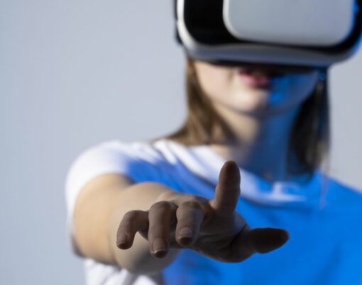 Woman using VR virtual reality glasses headset pointing at objects in metaverse. Virtual reality metaverse.