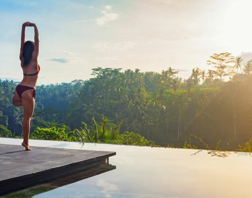 Good morning with yoga meditating on sunrise background
