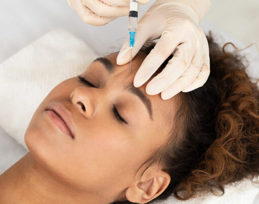 Beauty Procedure. Beautician Expert Injecting Botox In Female Forehead