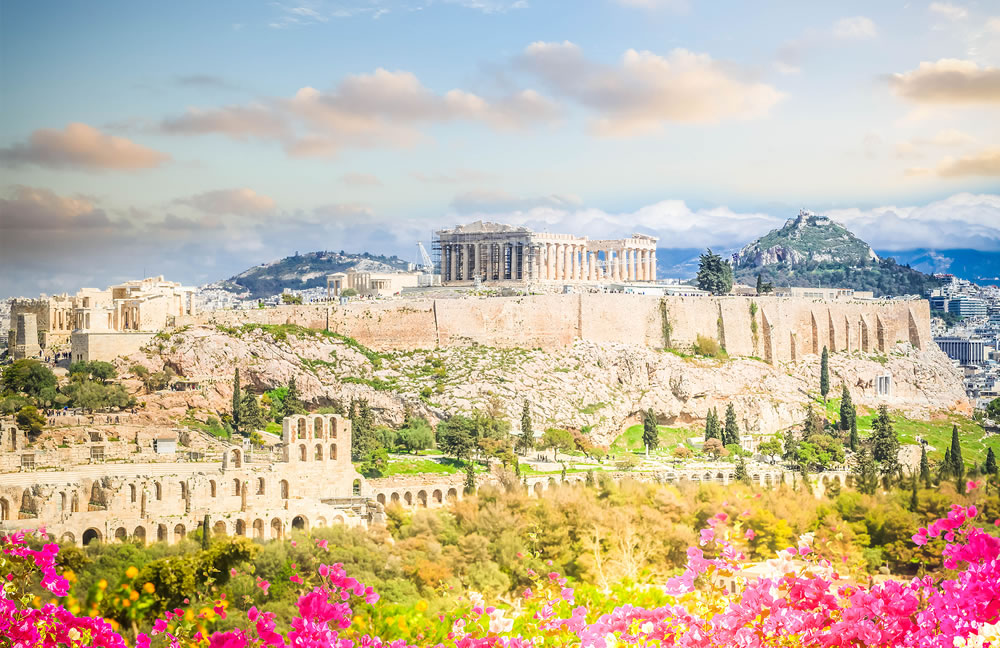 Famous skyline of Athens with Acropolis hill at sunset, Pathenon, Herodes Atticus amphitheater and Lycabettus Hill with flowers, Athens Greece