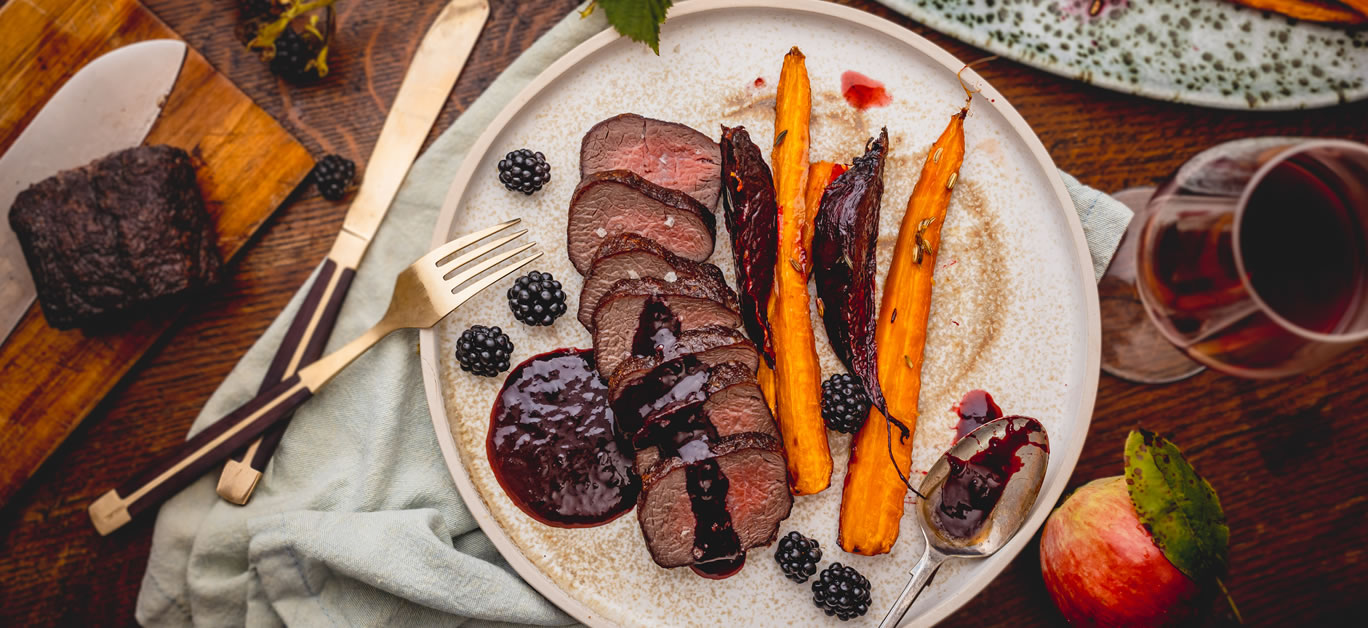Venison loin with blackberry sauce and roasted roots