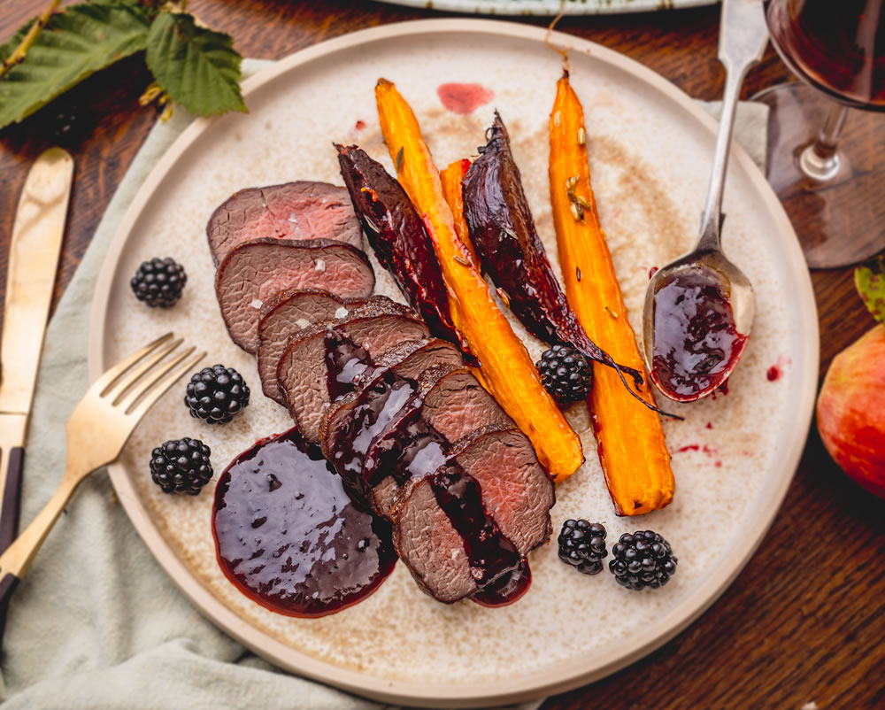 Venison loin with blackberry sauce and roasted roots