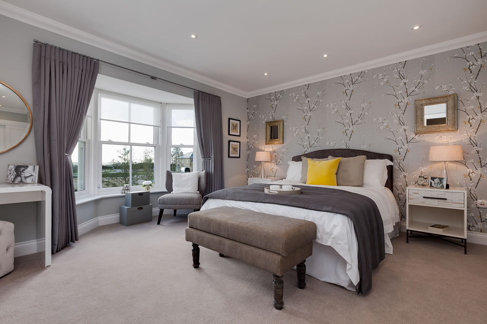 Modern stylish bedroom with luxury furniture and fabrics within desirable new home