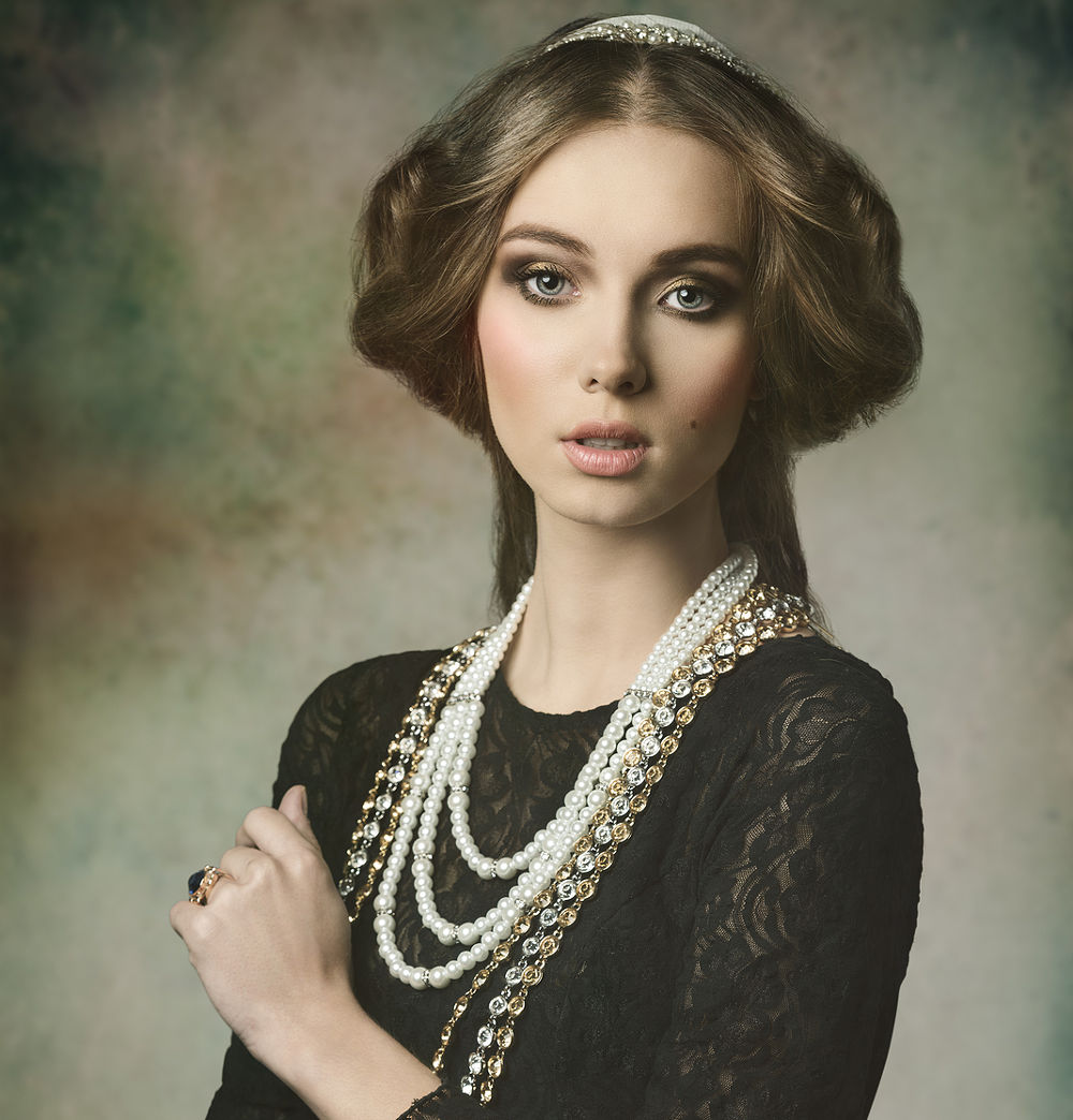 cute brunette girl posing in fantasy portrait wearing like a antique aristocratic lady with precious brilliant crown vintage hair-style and brilliant jewellery