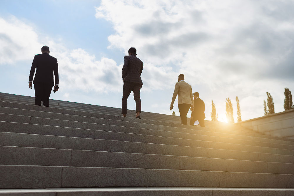 Business people climb the steps of the city stairs. impersonal rising up. Career growth and advancement. Increasing and improving skills. Salary increase