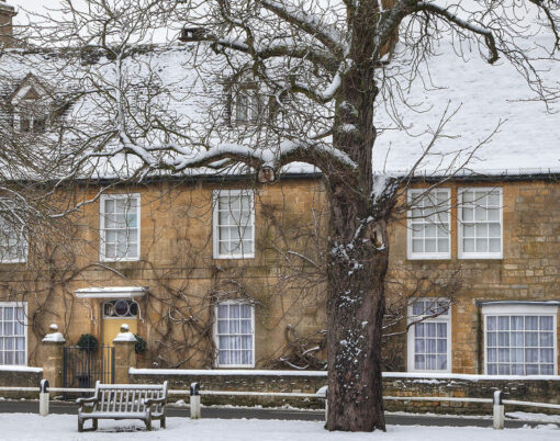 Snow covered character property overlooking the village green Broadway Worcestershire England.