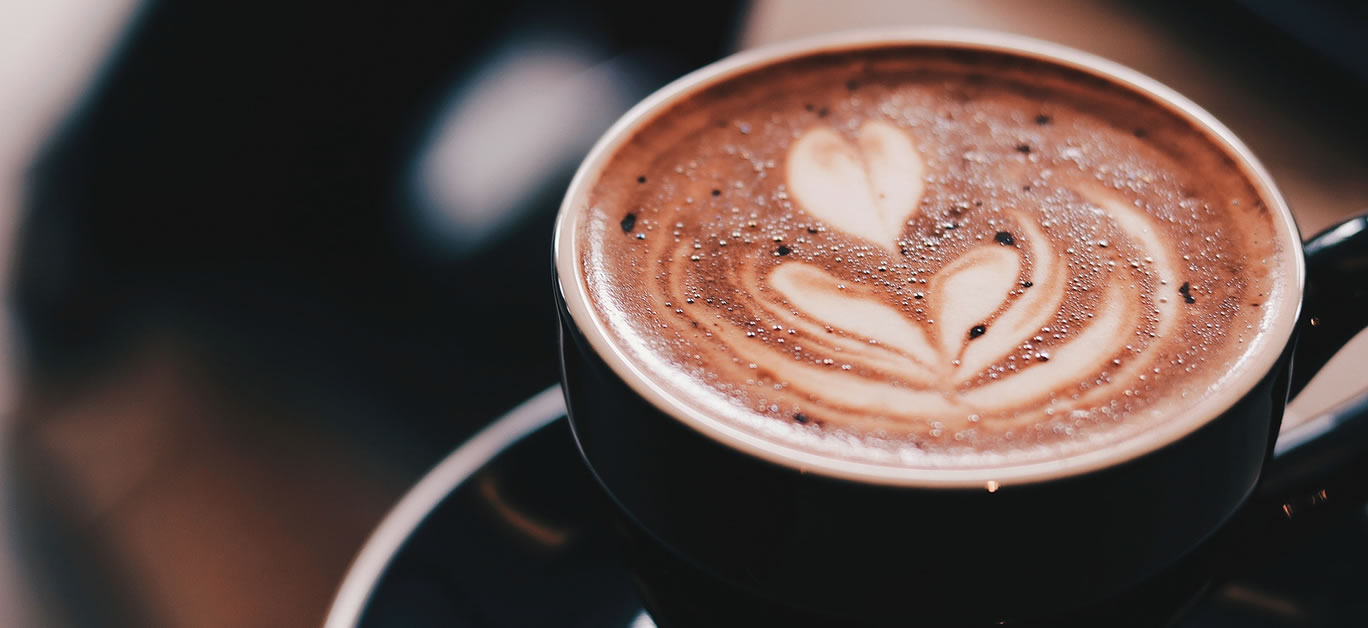 Espresso coffee in a white ceramic cup, close-up, selective focus.