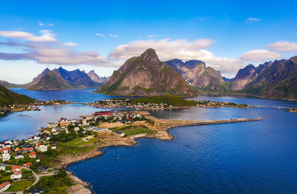 Aerial view of Reine fishing village surrounded by high mountains and fjords on Lofoten islands in Norway.
