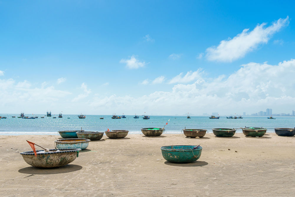 Basket boats at My Khe beach in Da Nang city, Vietnam. Local fishing boats of Danang have become iconic to Vietnam. Southeast Asia travel concept