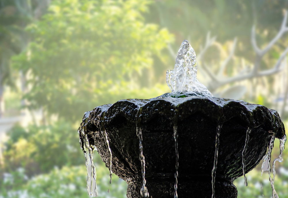 Fountain for garden decoration on blurred background. Backyard, front garden and around the house.