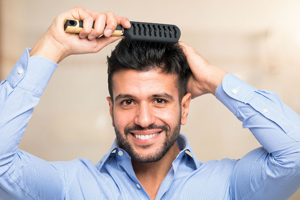happy man with comb in hair