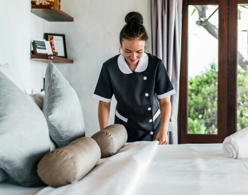Housekeeper cleaning a hotel room